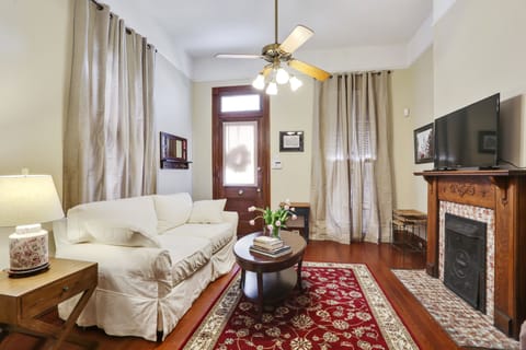 Living room with queen sofa sleeper and large flat screen TV.