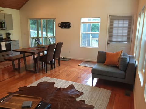 View front door and sliding glass door to newly enlarged screened in porch area.