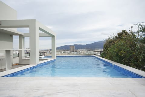 Private swimming pool at roof garden with panoramic city view