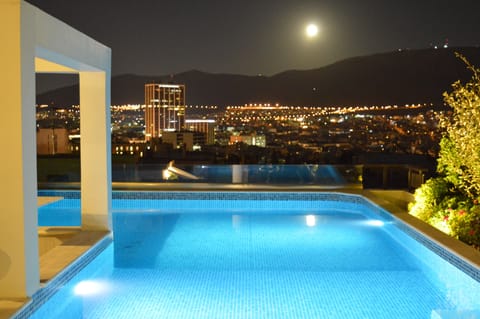 Private swimming pool at roof garden with panoramic city view
