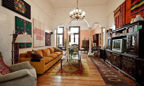 View of family room separated by arches from the formal living area.  Balconies.