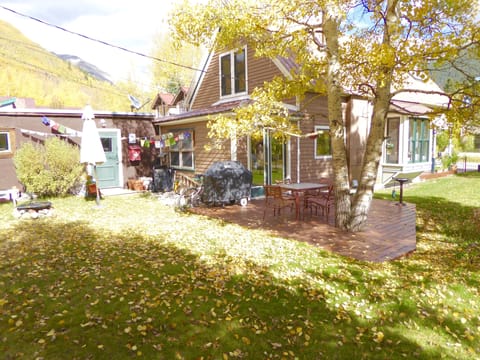 Deck with gas grill and outdoor dining table.