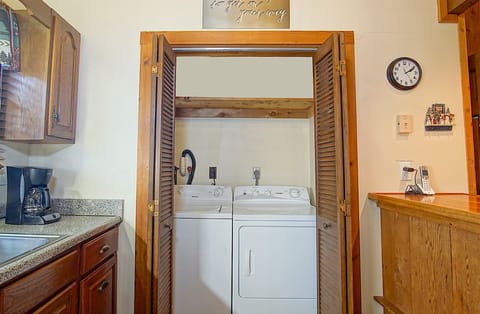The washer/dryer is located in a closet in the kitchen.