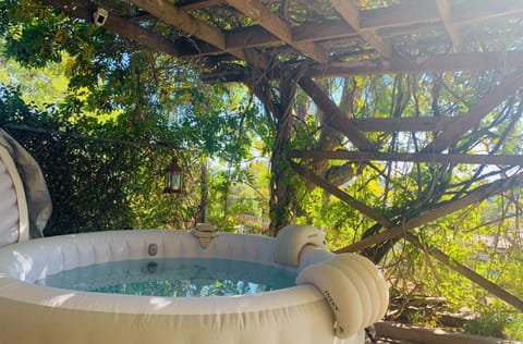 Hot-tube under a wonderful pergola, in a garden full of flowers & birds.