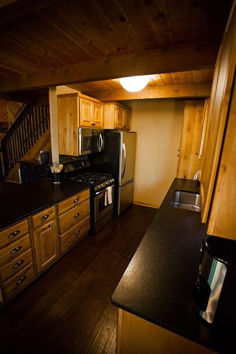 View of the kitchen with granite counter tops and stainless steel appliances including gas cooktop