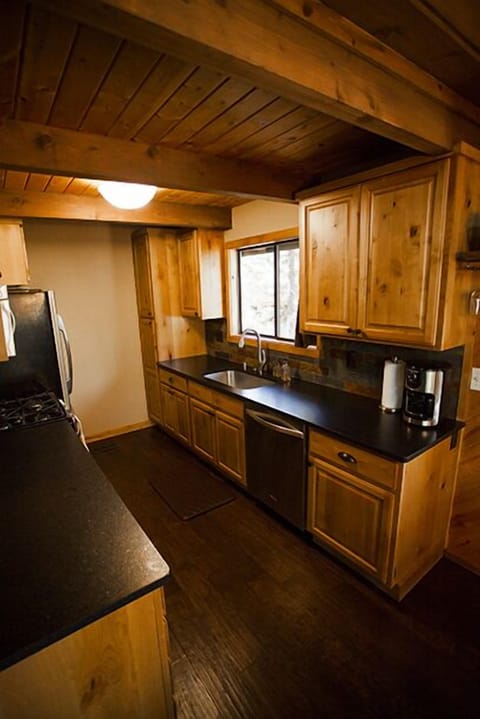 View of the kitchen with granite counter tops and stainless steel appliances including dishwasher.