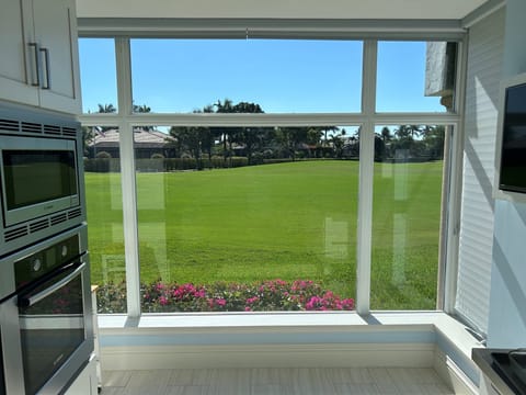 East facing sunny large kitchen with impact window overlooking the golf course  