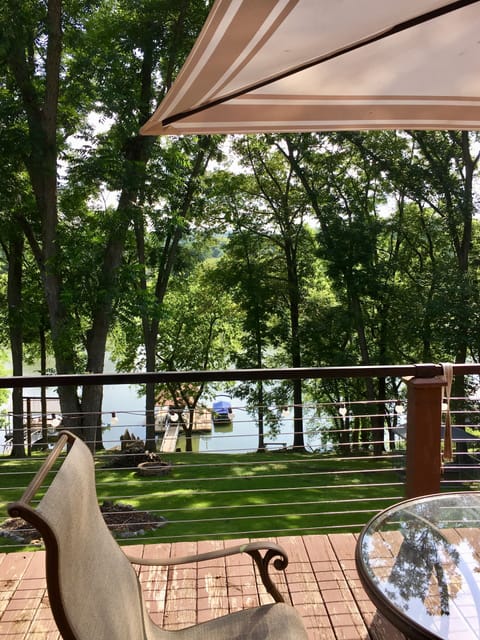 View of Tim’s Ford Lake . Back porch with outdoor dining tables and chairs.