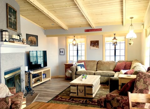 The large living room offers a home theater, sofa bed, and a gas fireplace. 