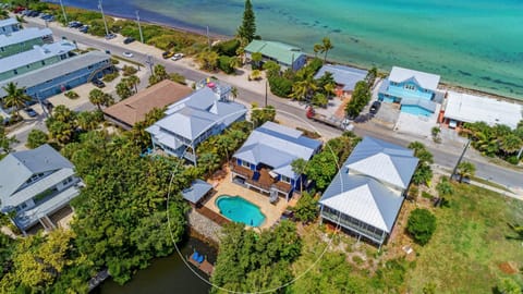 Private Separate Tiki Bar, No reason to ever leave home! 10 Resort Style Chaise Lounges, Dining for 16. SW Exposure for Sun Lovers! 20 degrees warmer than anywhere else on the island in the pool area. Canal direct access.