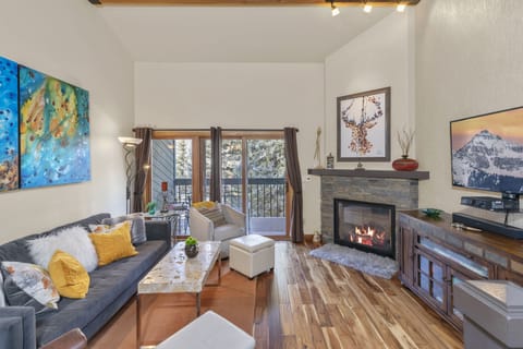 Upper level living area with fireplace, deck, designer decor
