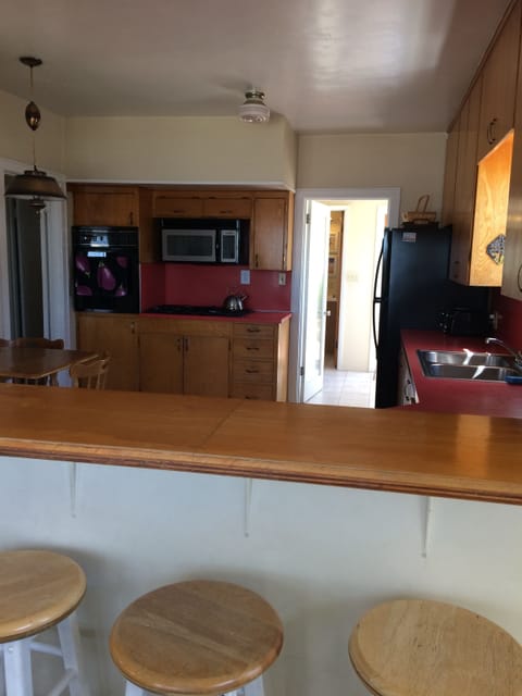 Counter looking into Kitchen with three stools