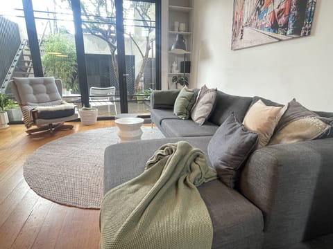 Lounge room looking to back deck and upper terrace with city views