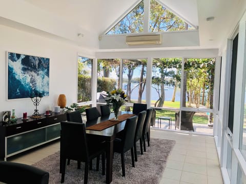 Dining room opens out to the pool and the lake