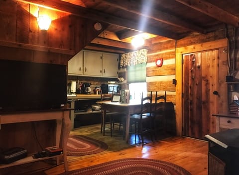 The kitchen has a table for dining, a stove, microwave, toaster, oven and fridge