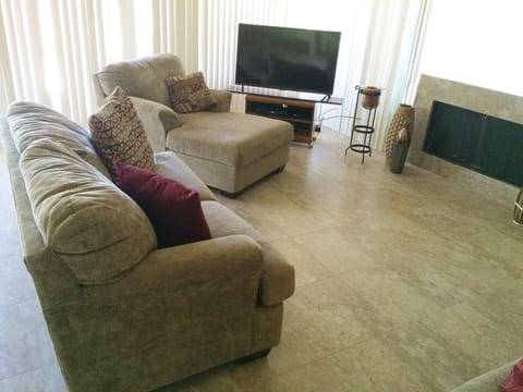 Living room: plush seating around the fireplace and the 50" flat screen TV.