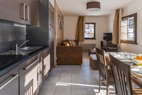 Prepare meals in the kitchenette and enjoy them at the dining table.