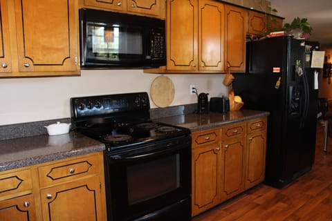 Kitchen with lots of counter space, microwave and side by side refrigerator 