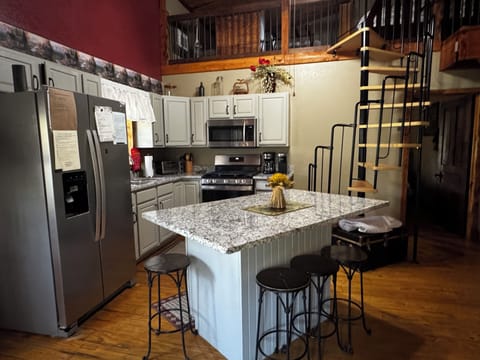 Kitchen with view of spiral staircase to the loft area.