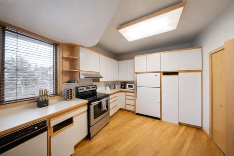 Your fully equipped kitchen features modern appliances, ample counter space, and warm wood accents for delightful home-cooked meals.