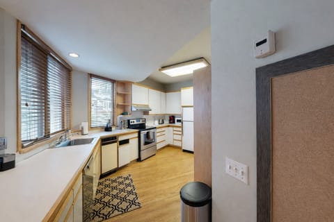 Your fully equipped kitchen features modern appliances, ample counter space, and warm wood accents for delightful home-cooked meals.