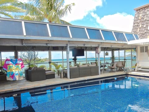 Bayview deck on main level w/ lounge and dining area adjacent to salt water pool