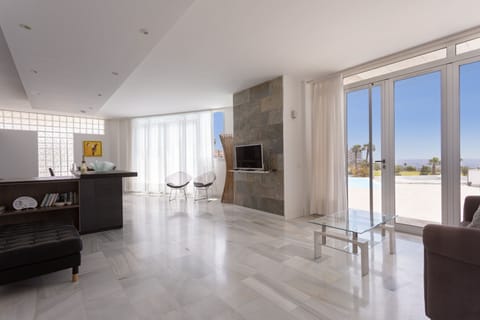 A spacious entrance/living room, with quality furniture; Access to terrace +pool