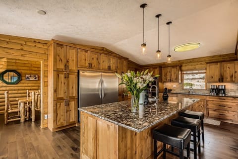 Kitchen with large island, full size freezer and full size refrigerator