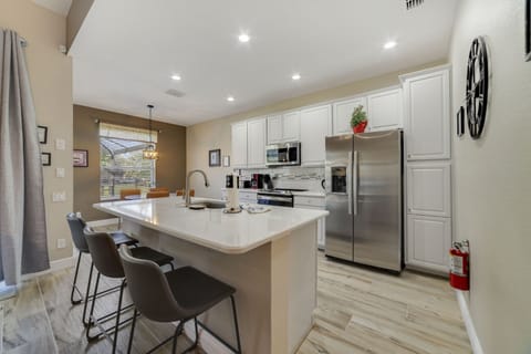 Open and spacious kitchen with three barstools