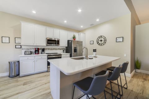 Open and spacious kitchen with three barstools