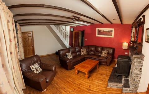 Sitting room with exposed beams and woodburning stove 