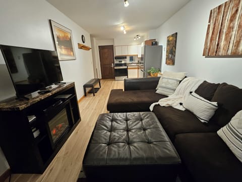 Living room with cozy warm fireplace and comfy sofa that seats 5