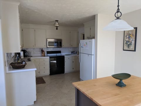 The full kitchen is sparkling clean, well-stocked, and spacious.