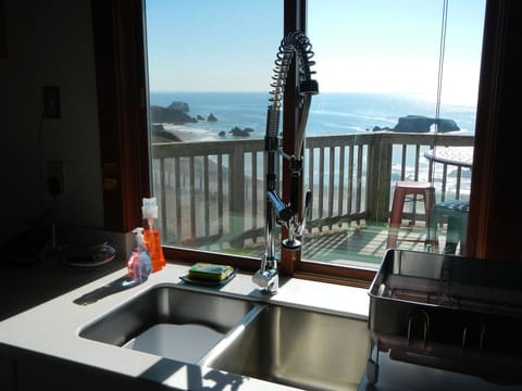 View of front deck while washing dishes; kitchen door to front deck on left.