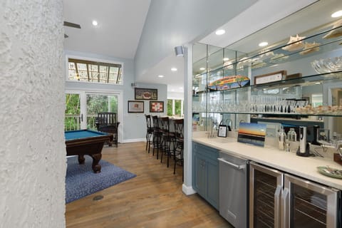 The billiard room has a full sized pool table & a 65" 4K TV along with a wet bar with ice maker & wine fridge. Great space to watch a game while playing a game of pool.