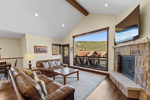Sink into plush leather sofas by your crackling fireplace while soaking in breathtaking mountain views through expansive windows.