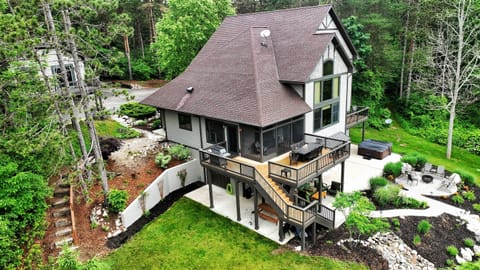 Exterior Oasis: Discover spacious decks, luxurious hot tub, outdoor covered bar, lush landscaping and nature's tranquility all around!