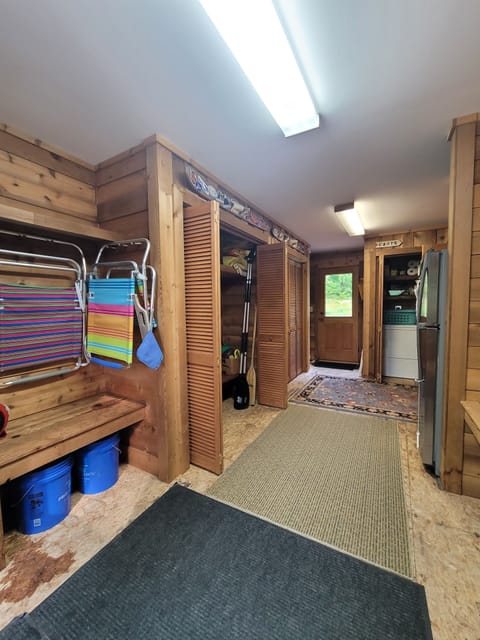 Mudroom with plenty of storage for gear, extra refrigerator, washer and dryer