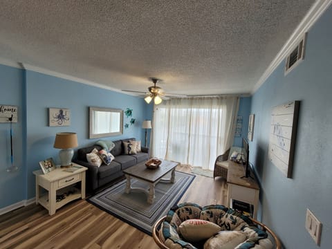 Big comfy couch and Papisan chair. Lots of room for game nights! 42" Smart Tv