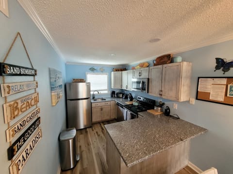 Spacious kitchen with all the things you need to cook a meal. Fun bar area!