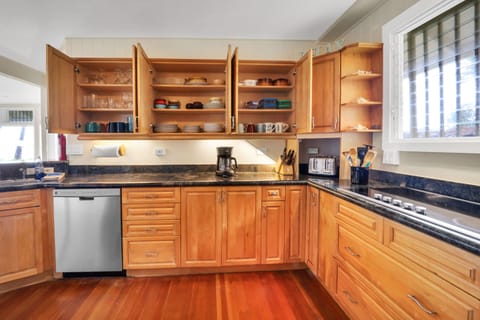 Fully equipped kitchen with oven, stovetop, microwave, dishwasher, coffee maker