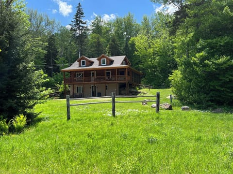 Mountainside cabin surrounded by forest.