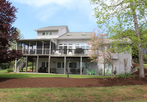 Back of Oasis.  Screened porch with seating and seating on bottom floor as well