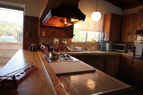 A large bar counter separates the kitchen and dining area.