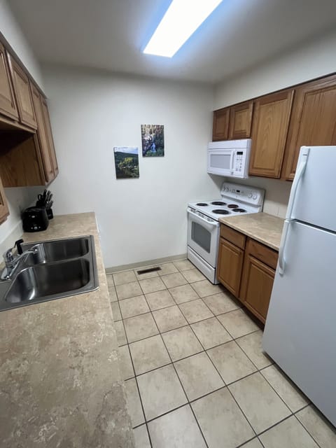 Kitchen with range, dishwasher, microwave, and small appliances.