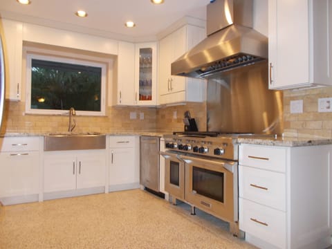 Gourmet kitchen has three ovens, granite countertops and Italian Terrazzo floor.