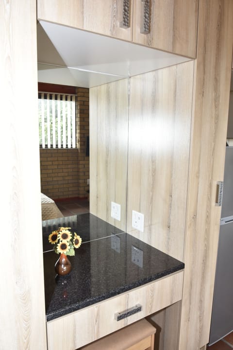 The built-in vanity has a countertop plug that fits a two-prong plug and charger