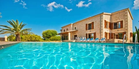 Swimming pool with the Villa of background