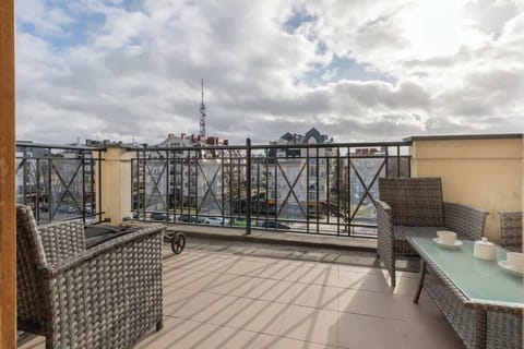 A small balcony or terrace with a cozy seating area, providing an outdoor space to enjoy the surrounding views and fresh air.