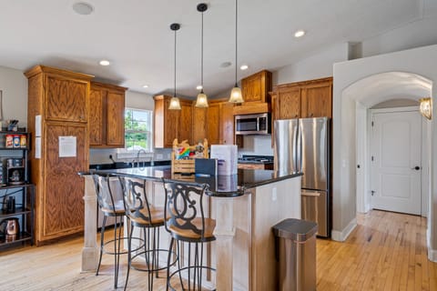 The kitchen is fully stocked with plates and silverware for 20+